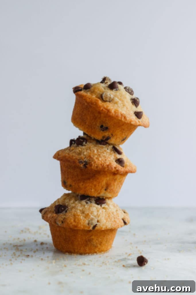 Decadent Dairy-Free Chocolate Chip Muffins 6 A stack of four fluffy dairy-free chocolate chip muffins, highlighting their golden color and tempting tops.