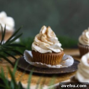 Effortlessly Fluffy Gingerbread Cupcakes 2 A perfectly baked and frosted gingerbread cupcake, unwrapped and ready to be enjoyed.