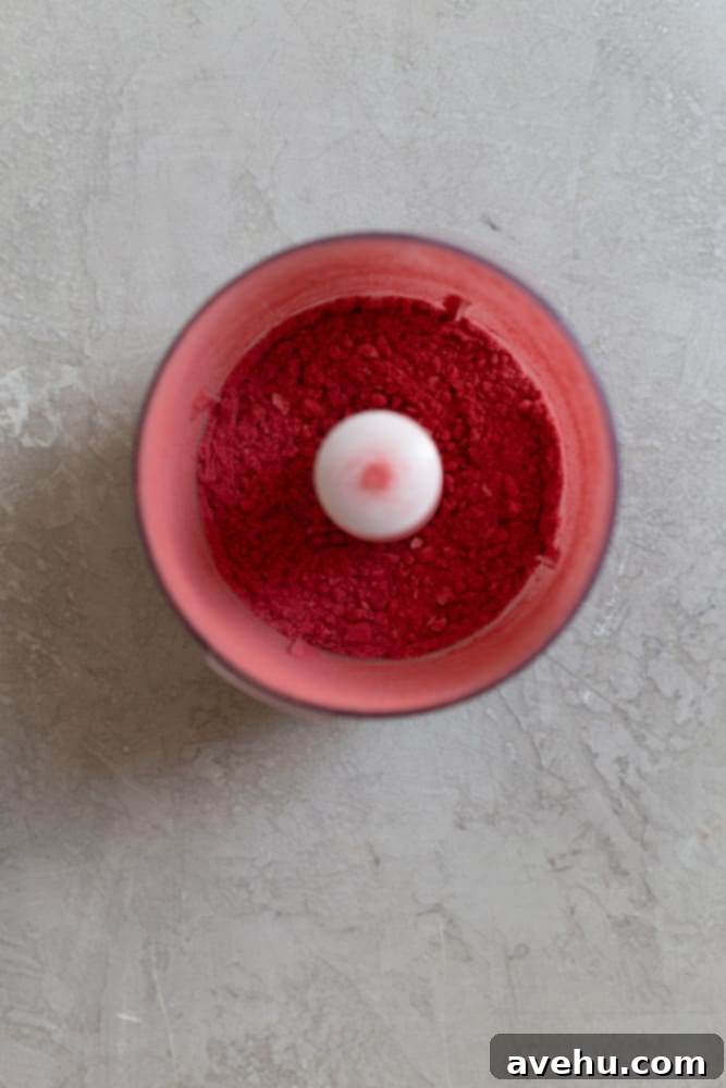 Aromatic Strawberry Basil Cake with Strawberry Buttercream 11 Finely pulverized freeze-dried strawberries, now a vibrant pink powder, in a white bowl.