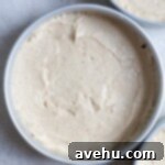 Aromatic Strawberry Basil Cake with Strawberry Buttercream 18 White cake batter carefully poured into a round baking pan, ready for the oven.