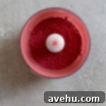 Aromatic Strawberry Basil Cake with Strawberry Buttercream 21 Finely pulverized freeze-dried strawberries, now a vibrant pink powder, in a white bowl.