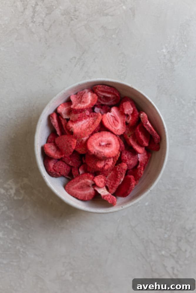 Aromatic Strawberry Basil Cake with Strawberry Buttercream 10 A bowl filled with light, crisp freeze-dried strawberry pieces, ready to be processed for buttercream.
