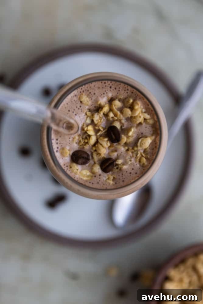 Energizing 3-Minute Greek Yogurt Coffee Smoothie 3 The top of a coffee smoothie in a glass, generously sprinkled with granola for added texture.