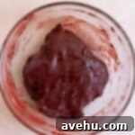 Effortless Red Velvet Cake Mix Cookies 4 Red velvet cookie dough in a glass bowl.