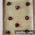 Effortless Red Velvet Cake Mix Cookies 6 Cake mix cookie dough on a parchment lined baking sheet.