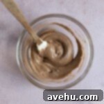 Chocolate cake batter in a small glass bowl.