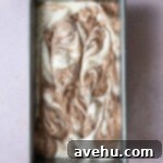 Swirled vanilla and chocolate batter in a loaf pan.