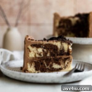 One-Bowl Wonder: Moist Marble Cake 2 A beautiful slice of one-batter moist marble cake with chocolate cream cheese frosting, showcasing its delightful swirls and texture.