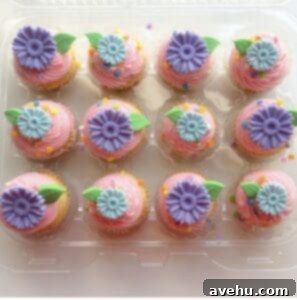 Sweet Secrets to Adorable Cupcakes 7 Mini cupcakes decorated with purple and blue fondant flowers.