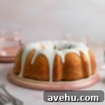 Achieve Perfect Frosting Consistency Instantly 7 A bundt cake drizzled with thick white frosting on a pink plate.