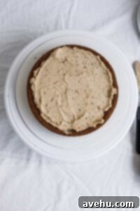 From Sunken to Superb: 5 Reasons Your Cake Sinks and 3 Simple Fixes 4 A cake frosted with a layer of buttercream frosting.