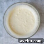 Decadent Banana Fudge Brownies 4 Whipped eggs and sugar in a glass bowl.