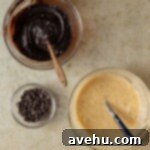 Ultimate Banana Bread Brownies 5 Two bowls on a tan surface, one with brownie batter and the other with banana bread batter.