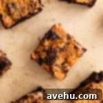 Ultimate Banana Bread Brownies 9 Banana bread brownies cut on a tan surface next to each other.