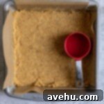 Graham cracker crust pressed into a brownie pan.