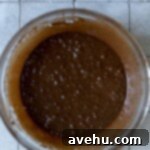 Wet brownie batter ingredients in bowl.