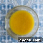 Irresistible White Chocolate Blondies 3 Melted white chocolate and butter in a small glass bowl.