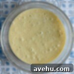 Irresistible White Chocolate Blondies 5 White chocolate brownie batter in a glass bowl.