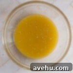 Simple Chocolate Chip Cookies No Brown Sugar Required 3 Melted butter and eggs mixed in a glass bowl.