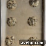 Simple Chocolate Chip Cookies No Brown Sugar Required 6 Chocolate chip cookie dough on a parchment lined cookie sheet.