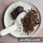 Simple Fudgy Black Forest Brownies 7 Shaved chocolate next to a peeler on a white plate.