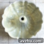 Handcrafted Fudgy Chocolate Brownie Masterpiece 3 A 10-cup bundt pan, thoroughly coated with baking spray and flour, ready for the fudgy chocolate brownie cake batter.