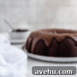 Handcrafted Fudgy Chocolate Brownie Masterpiece 8 Close-up of a beautifully baked fudgy chocolate brownie cake, with decadent chocolate frosting artfully drizzled down its sides, highlighting its rich texture.