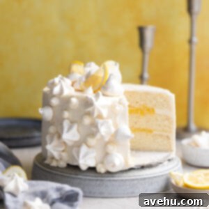 Velvet Zest Lemon Curd Cake 2 A lemon curd cake with a slice taken out of it.