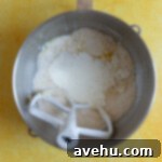 Velvet Zest Lemon Curd Cake 3 Wet and dry ingredients for lemon cake in a mixing bowl.