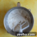 Velvet Zest Lemon Curd Cake 4 Lemon cake batter in a stainless steel bowl.