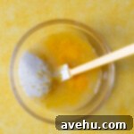 Velvet Zest Lemon Curd Cake 5 Eggs, lemon juice, and sugar in a glass bowl.