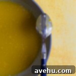 Velvet Zest Lemon Curd Cake 7 The back of a spoon coated with lemon curd.