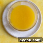 Velvet Zest Lemon Curd Cake 10 Lemon curd in a small glass container.