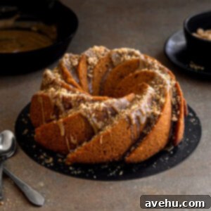 A bundt cake drizzled with glaze and streusel.