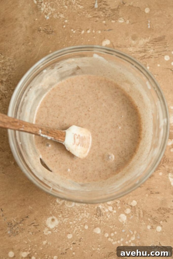 Whip Up 60-Second Cinnamon Cake Drizzle 3 Cinnamon glaze in a glass bowl, mixed and smooth.