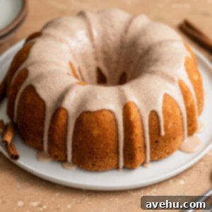 Whip Up 60-Second Cinnamon Cake Drizzle 4 A cinnamon bundt cake with cinnamon glaze on a white plate, ready to be served.