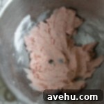 Heavenly Chocolate Strawberry Cupcakes 7 Strawberry frosting in a mixing bowl.