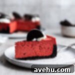 Clever Sour Cream Replacements for Baking 2 A vibrant red velvet cheesecake slice, beautifully presented on a white plate, highlighting its creamy layers.