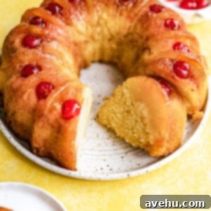 Golden Crown Pineapple Bundt Cake 2 A pineapple upside down bundt cake with a slice cut and on it's side.