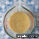 Zesty Citrus Bundt Bliss 5 Ingredients mixed in a measuring cup.