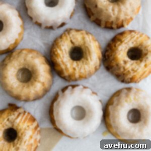 Luscious Mini Bundt Bites 2 A lot of mini cupcakes frosted on a light surface.