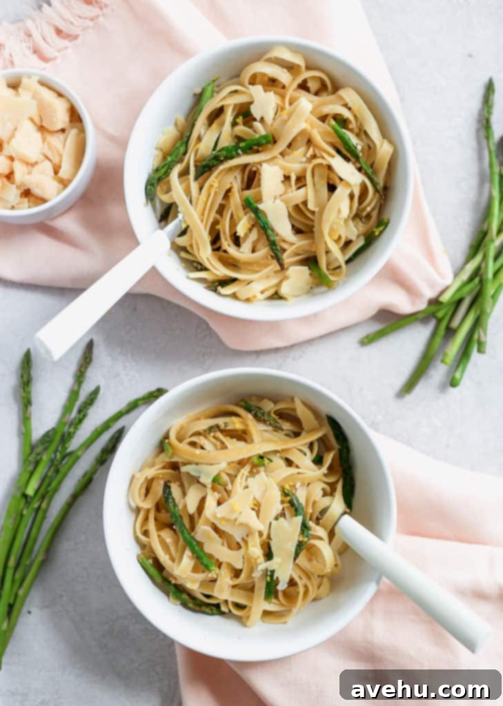 Asparagus and Lemon Fettuccine with Shaved Parmesan 2 Fettuccine pasta with asparagus served in two white bowls with pink napkins