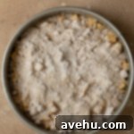 Velvet Apple Pie Cheesecake 6 A pre-baked cheesecake with sliced apples and streusel on top.