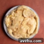 Crisp Puff Pastry Apple Dream 4 Thinly sliced Honeycrisp apples in a large glass mixing bowl, ready for the filling mixture.