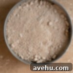 Effortless Graham Cracker Apple Pie 8 Streusel topping sprinkled over the apple filling in an unbaked pie.