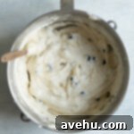 Bright & Zesty Lemon Blueberry Cupcakes 17 Cupcake batter with blueberries in it in a mixing bowl.