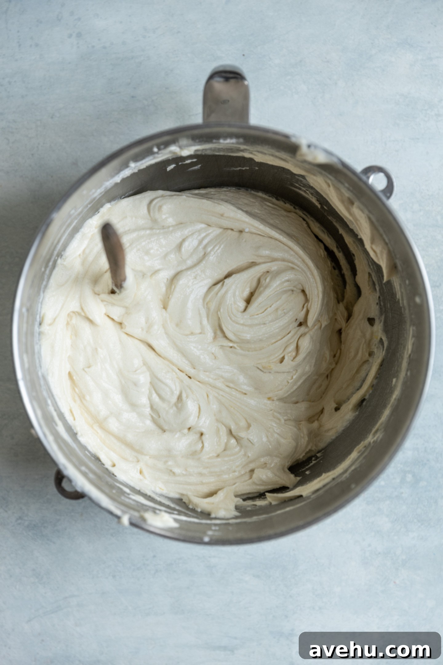 Bright & Zesty Lemon Blueberry Cupcakes 6 A visibly thick, yet light-colored cupcake batter resting in a mixing bowl, showcasing its readiness for baking.