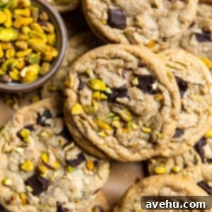 Pistachio chocolate chip cookies laid on top of each other.