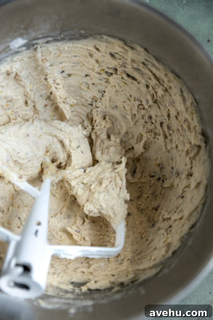 Buttery Pistachio Shortbread Logs 7 A batch of pistachio shortbread cookie dough, perfectly mixed and ready for shaping, showcasing the visible pistachio pieces.