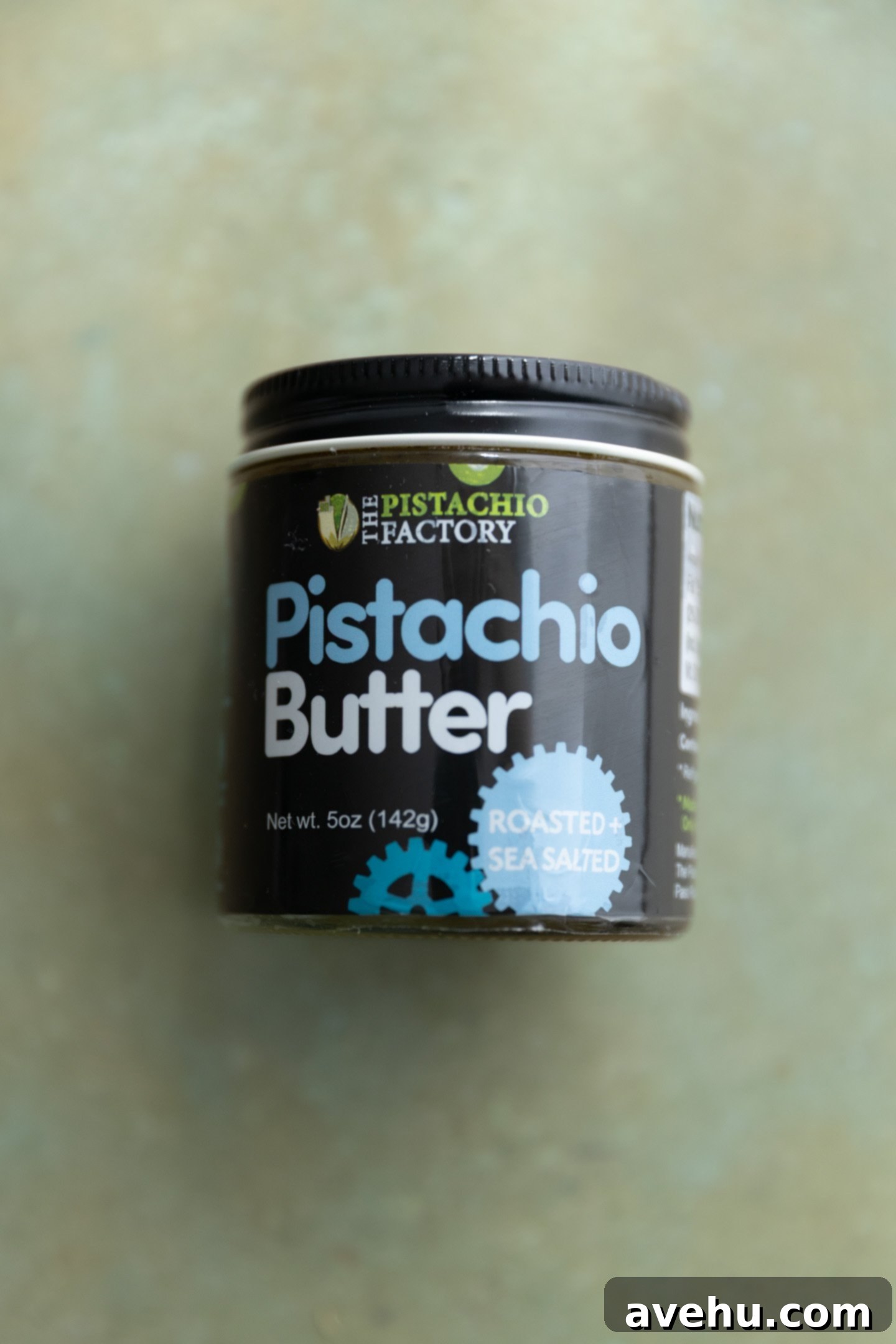 Effortless 5 Minute Pistachio Frosting 3 Pistachio butter on a green surface.